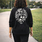 Black long sleeve Brand New Creation Tee, Back Female model walking on sidewalk, Christian Apparel