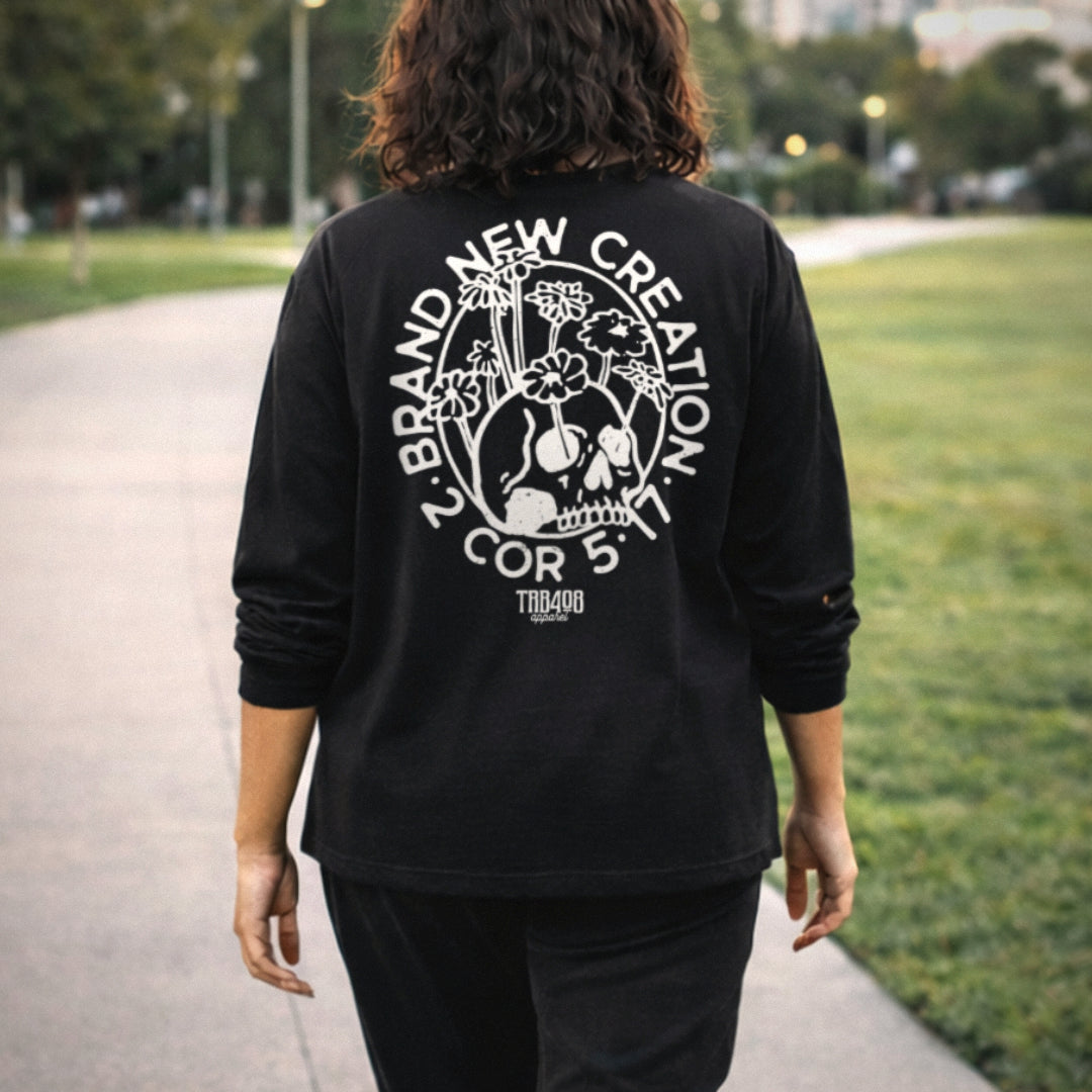 Black long sleeve Brand New Creation Tee, Back Female model walking on sidewalk, Christian Apparel